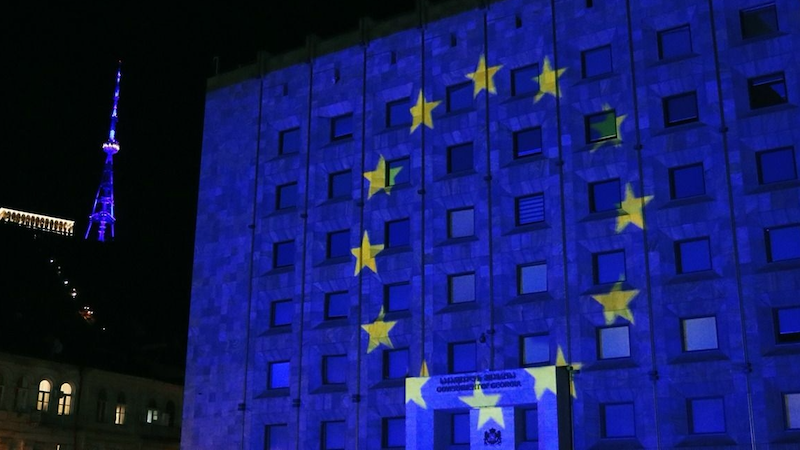 Georgia's Government Administration Building illuminated in the colors of the EU flag. Photo Credit: Facebook; Georgian government