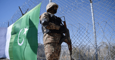 A Pakistani soldier stands guard next to fence bordering Afghanistan. Photo Credit: Mehr News Agency