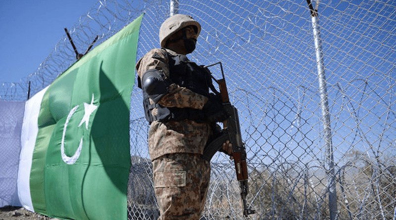 A Pakistani soldier stands guard next to fence bordering Afghanistan. Photo Credit: Mehr News Agency