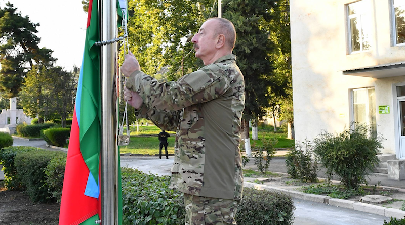 Azerbaijan's President Ilham Aliyev raises the national flag of the Republic of Azerbaijan in the town of Khojavand. Photo Credit: Azerbaijan Presidential Office