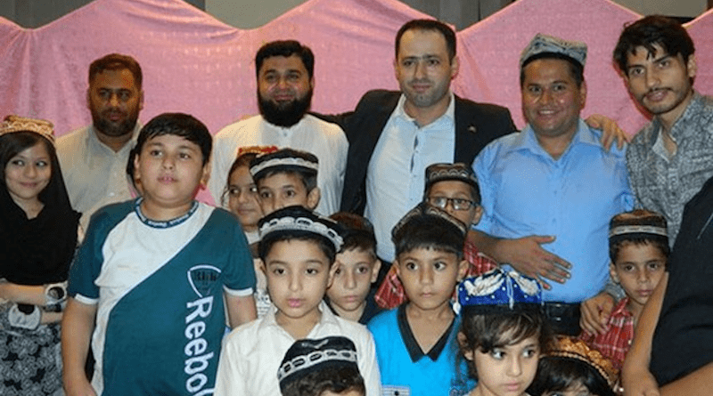 Omer Khan (2nd from R), founder of the Pakistan-based Omer Uyghur Trust, poses with Uyghur families and children living in Pakistan in November 2015. Photo Credit: RFA