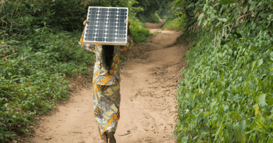 Woman carrying a solar pannel near Yangambi, DRC. Solar could be dominant power source by 2050, researchers have said. Copyright: Axel Fassio/CIFOR, (CC BY-NC-ND 2.0 DEED).