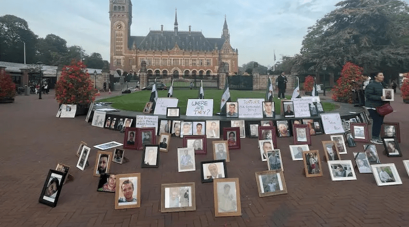 Photos of Syrians who have been detained or disappeared set up by their relatives, as part of a protest in front of the International Court of Justice in The Hague, Netherlands, on October 10, 2023. Photo Credit: © 2023 Human Rights Watch