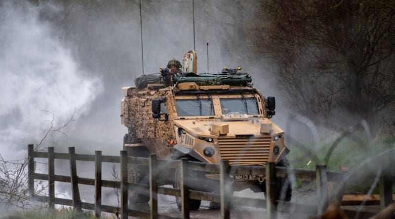 A soldier from the 2rd Battalion, The Royal Anglian Regiment, providing fire support inside a foxhound. Photo Credit: NATO