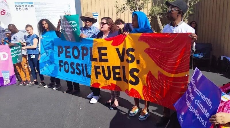 Campaigners protest against fossil fuels at last year's COP27 summit in Egypt's Sharm El Sheikh. During COP28 talks, countries committed less than US$200 million to the UN Adaptation Fund. Copyright: Mark Dixon, (CC BY-ND 2.0 DEED).