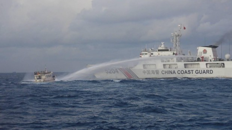 A China Coast Guard vessel fires a water cannon at a Philippine boat, Dec. 10, 2023. Photo Credit: Handout/Philippine Coast Guard