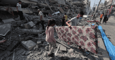 Gaza residents inspect the ruins of an apartment destroyed by Israeli airstrikes. Photo Credit: Palestinian News & Information Agency (Wafa), Wikipedia Commons