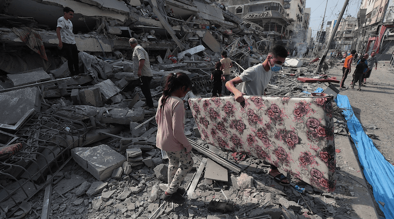 Gaza residents inspect the ruins of an apartment destroyed by Israeli airstrikes. Photo Credit: Palestinian News & Information Agency (Wafa), Wikipedia Commons