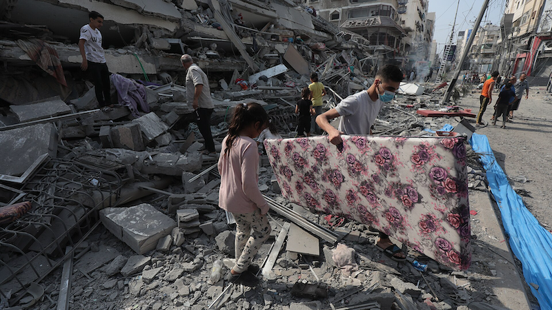 Gaza residents inspect the ruins of an apartment destroyed by Israeli airstrikes. Photo Credit: Palestinian News & Information Agency (Wafa), Wikipedia Commons