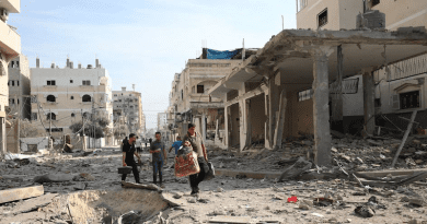 Men walk through the destroyed streets of Gaza. Photo Credit: WHO