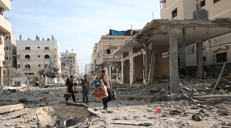 Men walk through the destroyed streets of Gaza. Photo Credit: WHO