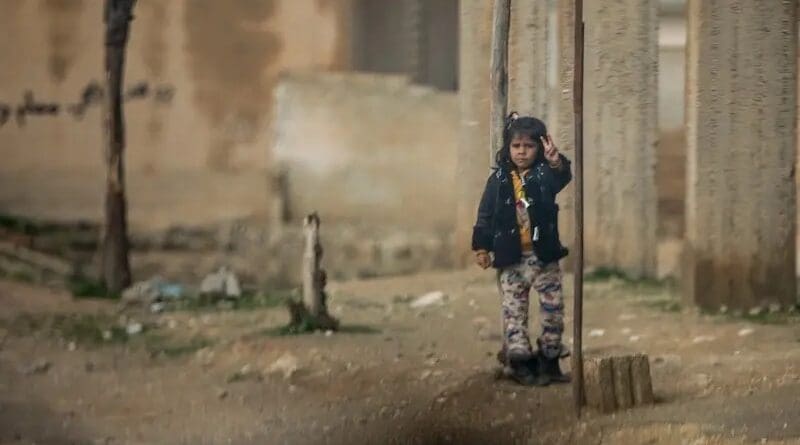 A Syrian girl gestures a peace sign to a passing Coalition Forces convoy in Ayn Issa, Syria. (U.S. Army Photo by Staff Sgt. Ray Boyington)