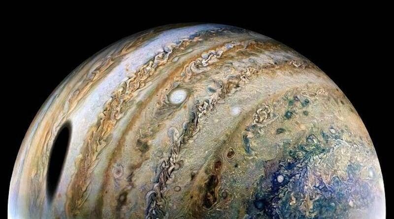Image of Jupiter taken by NASA's Juno spacecraft in February 2022. The dark spot is the shadow of the moon Ganymede. The colorful patterns are formed by clouds at different altitudes and made up mainly of ammonia ice, ammonium hydrosulfide and water. CREDIT: NASA/JPL-Caltech/SwRI/MSSS. Image processing by Thomas Thomopoulos