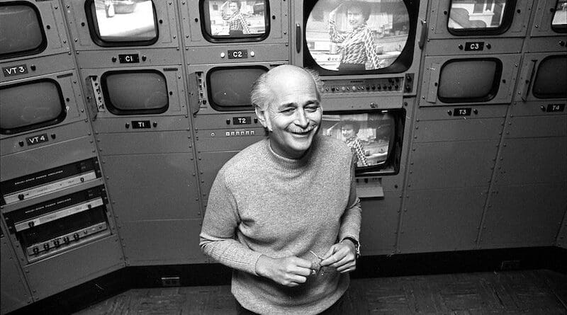 Norman Lear standing before a bank of camera monitors in 1975. Photo Credit: Kathleen Ballard, Los Angeles Times, Wikipedia Commons