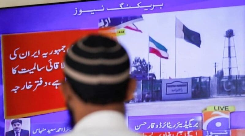 Man watches television report on Iran-Pakistan conflict. Photo Credit: Fars News Agency