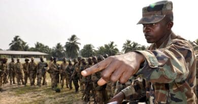 An Armed Forces of Liberia Corporal directs weapons and equipment turn-in for AFL soldiers returning from a four-month deployment on the Liberia and Ivory Coast border at Edward Binyah Kesselly Military Barracks. Photo Credit: Capt. Bryon McGarry, DOD