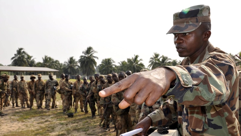 An Armed Forces of Liberia Corporal directs weapons and equipment turn-in for AFL soldiers returning from a four-month deployment on the Liberia and Ivory Coast border at Edward Binyah Kesselly Military Barracks. Photo Credit: Capt. Bryon McGarry, DOD