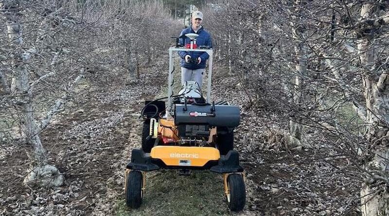 The system consists of a temperature-sensing device, a propane-fueled heater that adjusts its direction and angle automatically depending on wind direction, and an unmanned ground vehicle to move the heating system through an apple orchard. CREDIT: Penn State