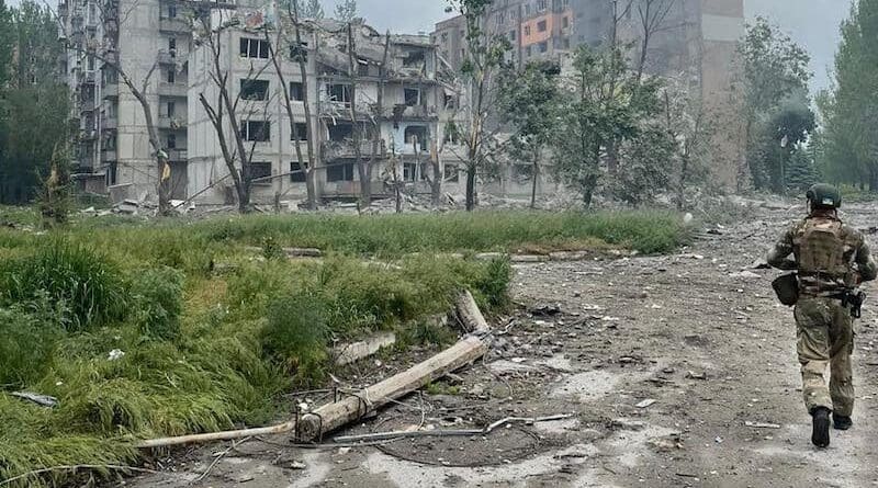 A Ukrainian soldier near a building struck by Russian shelling in Avdiivka. Photo Credit: Donetsk Regional Military Civil Administration, Wikipedia Commons