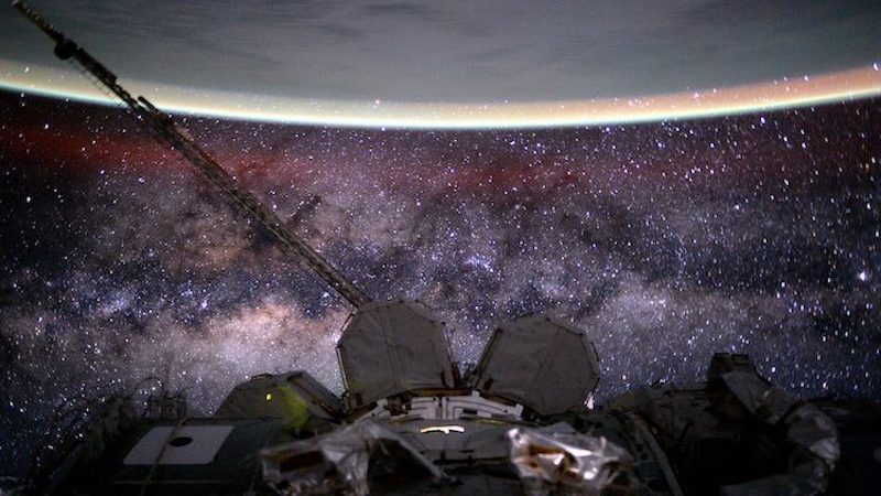Outer space from the International Space Station at 400 km (250 mi) altitude in low Earth orbit. In the background the Milky Way’s interstellar space is visible, as well as in the foreground, above Earth, the airglow of the ionosphere just below and beyond the so-defined edge of space the Kármán line in the thermosphere. Credit: NASA/Scott Kelly.