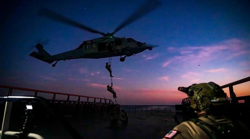 East coast based Naval Special Warfare operators fast-rope onto a training vessel during a maritime interdiction operation exercise in Virginia Beach, Va. Photo Credit: DOD