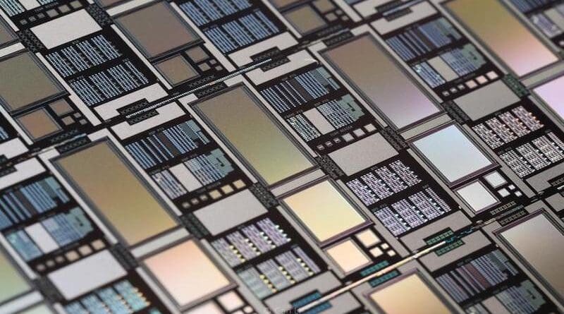 An exemplar photograph of an integrated chip containing memristor crossbar arrays of various sizes made at UMass Amherst. (Image taken by Can Li). CREDIT: Qiangfei Xia