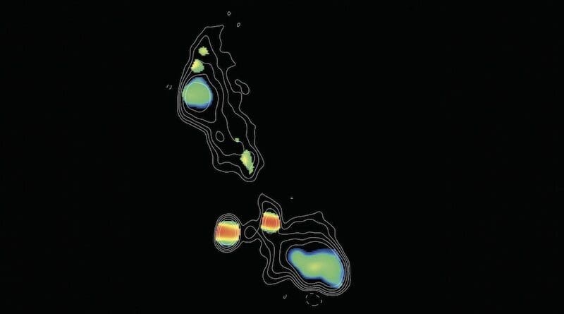This image, taken by the Very Long Baseline Array (VLBA), shows two supermassive black holes, which appear as the blobs with red strips. The black holes are in the center of an elliptical galaxy. Colors represent different spectral slopes in radio emission, with red showing the most dense regions surrounding the black holes. The black hole on the right has likely recently devoured a massive star, which caused it to shoot out two ultrafast jets. The ends of those jets appear as green blobs above and below the black hole. This object, called J0405+3803, is referred to as a Compact Symmetric Object (CSO), because its jets are relatively close-in (or compact), and short-lived, compared to other black holes with much larger jets. CREDIT: H.L. Maness/Grinnell College