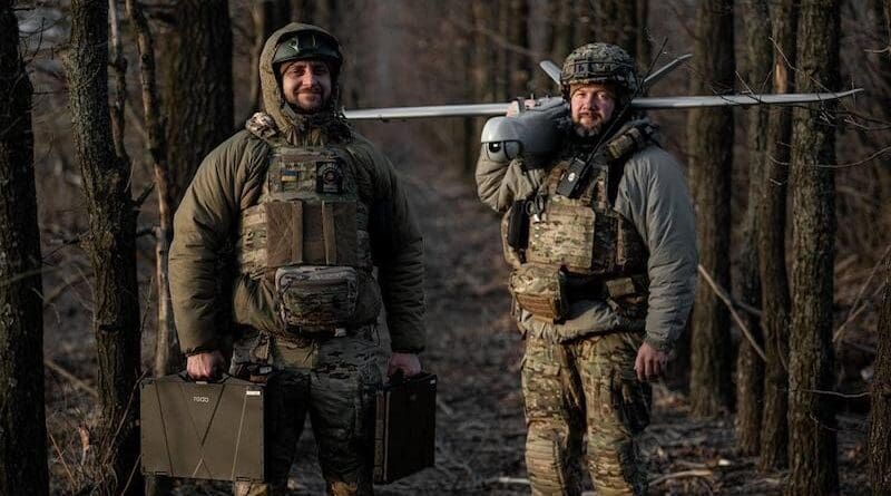 Ukrainian soldiers pose with a drone. Photo Credit: Anton Sheveliov, Ukraine Ministry of Defence