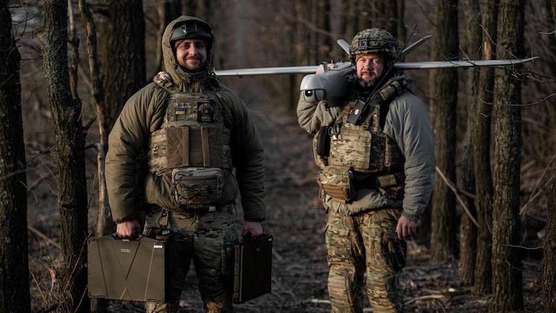 Ukrainian soldiers pose with a drone. Photo Credit: Anton Sheveliov, Ukraine Ministry of Defence