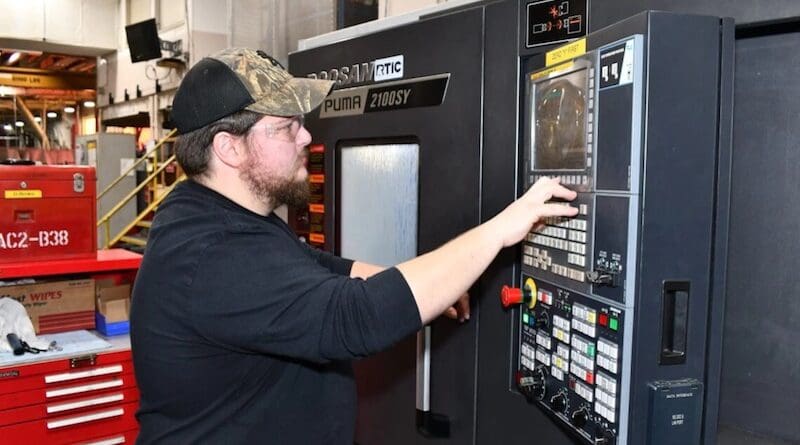 A machinist monitors a computerized lathe in the manufacturing machine shop at Fleet Readiness Center East in Cherry Point, N.C. Photo Credit: Heather Wilburn, DOD