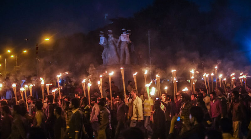 Demonstrators hold torches for a commemoration of the Bangladesh genocide. Photo Credit: Mehdi Hasan Khan, Wikipedia Commons