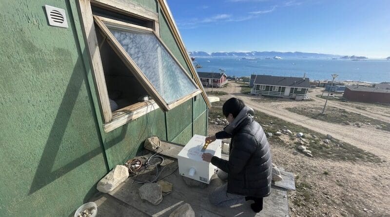 Tomoki Kajikawa, co-author of the study, installing the PM2.5 measurement system at the site in Qaanaaq (Photo provided by Tomoki Kajikawa)