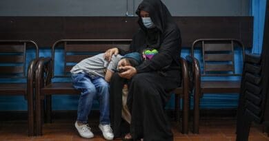 A Rohingya mother and her child sit on a bench while waiting to see a doctor at the Qatar Fund for Development Clinic in Selayang, Kuala Lumpur. Photo Credit: S. Mahfuz/BenarNews
