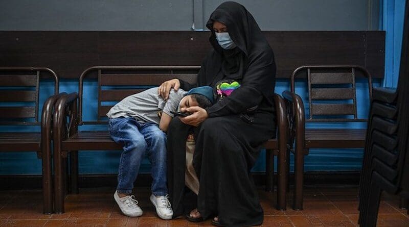 A Rohingya mother and her child sit on a bench while waiting to see a doctor at the Qatar Fund for Development Clinic in Selayang, Kuala Lumpur. Photo Credit: S. Mahfuz/BenarNews