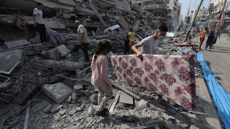 Residents inspect the ruins of an apartment destroyed by Israeli airstrikes in Gaza. Photo Credit: Palestinian News & Information Agency (Wafa), Wikipedia Commons