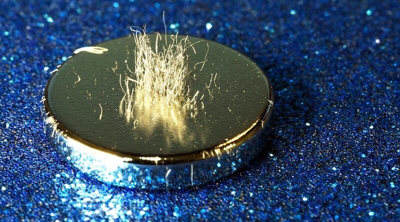 Metal shavings stand vertically atop a rare earth magnet. Photo Credit: C. Todd Lopez, DOD