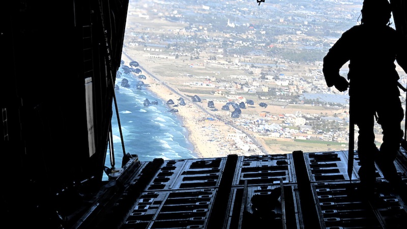 An Air Force loadmaster releases pallets of humanitarian assistance over Gaza, March 2, 2024. Photo Credit: DOD