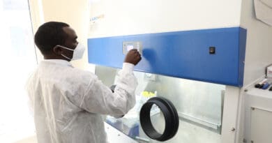 A scientist at Nairobi's Kenyatta National Hospital operating COVID-19 diagnostics equipment provided by The International Atomic Energy Agency in 2021. African scientists have criticised the WHO's draft international treaty for pandemic preparedness and response. Copyright: C. Madara / Nuclear Power and Energy Agency (CC BY 2.0 DEED), This photo was cropped.