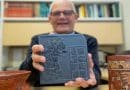 UNIVERSITY OF CINCINNATI PROFESSOR DAVID LENTZ HOLDS UP A REPRODUCTION TILE FEATURING ANCIENT MAYA GLYPHS. RESEARCHERS DISCOVERED EVIDENCE OF CEREMONIAL OFFERINGS AT THE SITE OF AN ANCIENT MAYA BALLCOURT IN YAXNOHCAH, MEXICO. CREDIT: ANDREW HIGLEY