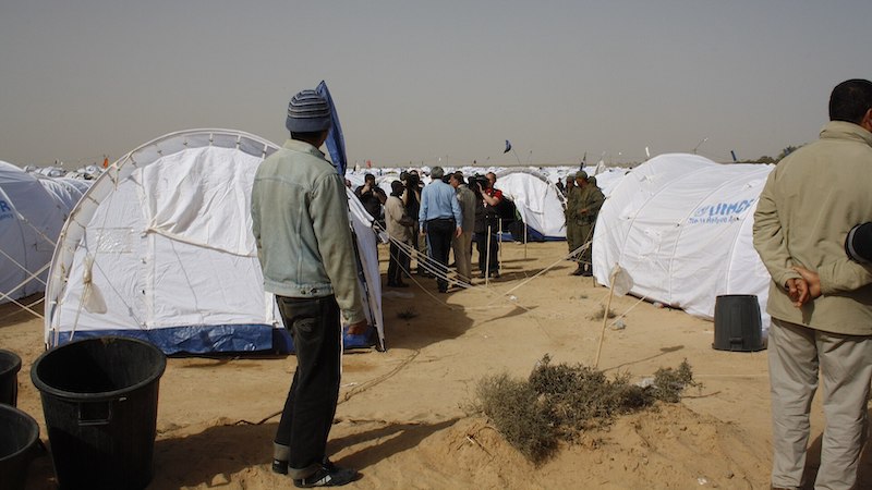 File photo of a transit camp for refugees near the Libyan-Tunisian border. Photo Credit: DFID - UK Department for International Development, Wikimedia Commons