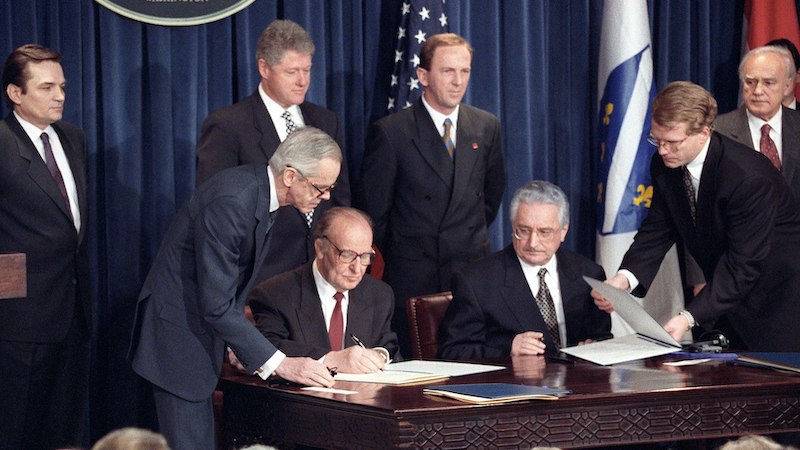 Bosnian President Alija Izetbegovic and Croatian President Franjo Tudjman sign the Croat-Muslim Federation Peace Agreement. Photo Credit: CIA, Wikipedia Commons