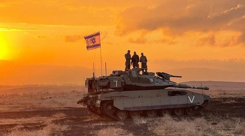 Israeli soldiers aboard a tank. Photo Credit: IDF