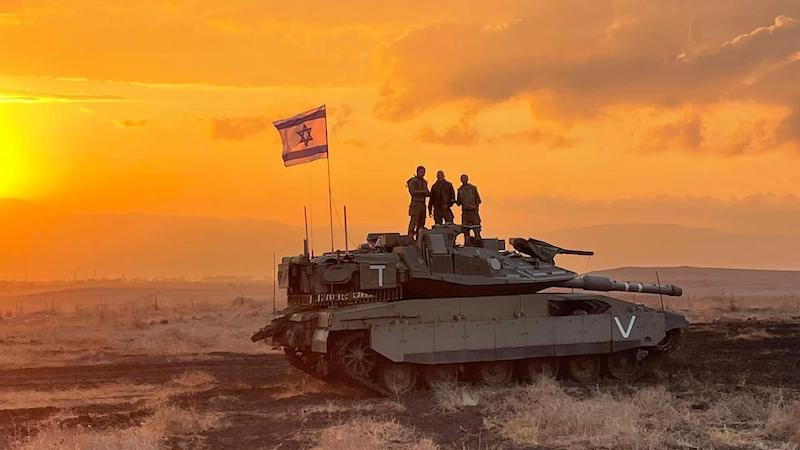 Israeli soldiers aboard a tank. Photo Credit: IDF