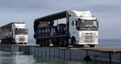 Trucks delivering humanitarian aid to Gaza cross temporary pier. Photo Credit: CENTCOM