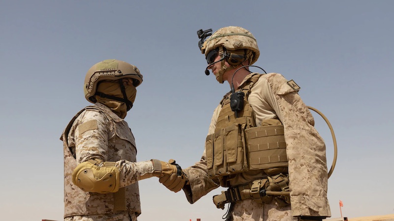 U.S. Marine Corps Lance Cpl. Ayden Kelso, right, shakes hands with a member the Royal Saudi armed forces during Exercise Native Fury 24 in Saudi Arabia. Photo Credit: DOD