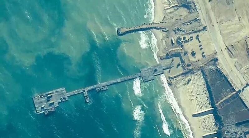 U.S. Army Soldiers with the 7th Transportation Brigade (Expeditionary), U.S. Navy Sailors assigned to Amphibious Construction Battalion 1, and Israel Defense Forces emplace the Trident Pier on the Gaza coast, May 16, 2024. Photo Credit: DOD