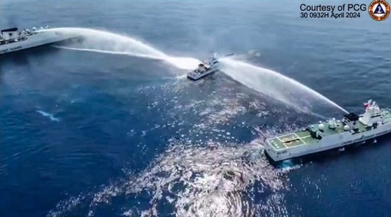 The BRP Bagacay (center), a Philippine Coast Guard ship, is hit by water cannon fired by Chinese coast guard ships near Scarborough Shoal in the South China Sea, in this frame grab from a handout video filmed and released April 30, 2024. [Handout/Philippine Coast Guard]