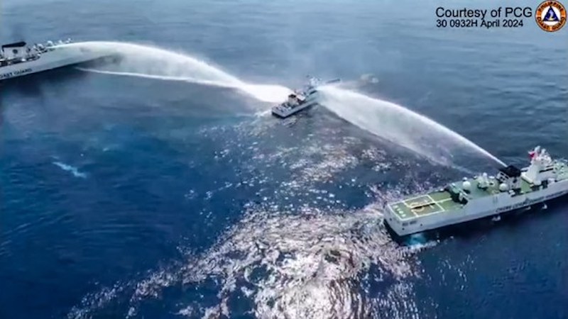 The BRP Bagacay (center), a Philippine Coast Guard ship, is hit by water cannon fired by Chinese coast guard ships near Scarborough Shoal in the South China Sea, in this frame grab from a handout video filmed and released April 30, 2024. [Handout/Philippine Coast Guard]