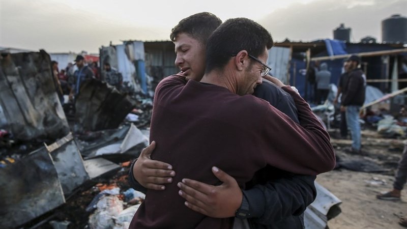 Palestinians at the site of an Israeli strike on a camp for internally displaced people in Rafah, Gaza. Photo Credit: Tasnim News Agency