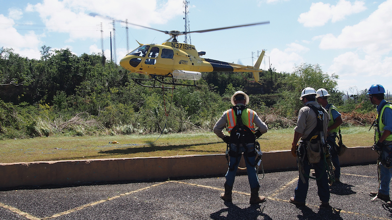 Linemen contracted by U.S. Army Corps of Engineers prepare to be sling-loaded from helicopters to inspect tops of high-voltage transmission towers and anchor lines that hold them in place after roughly 80 percent of grid was affected by storms, Aguadilla Pueblo, Puerto Rico, February 16, 2018 (U.S. Army Corps of Engineers/Michael N. Meyer)